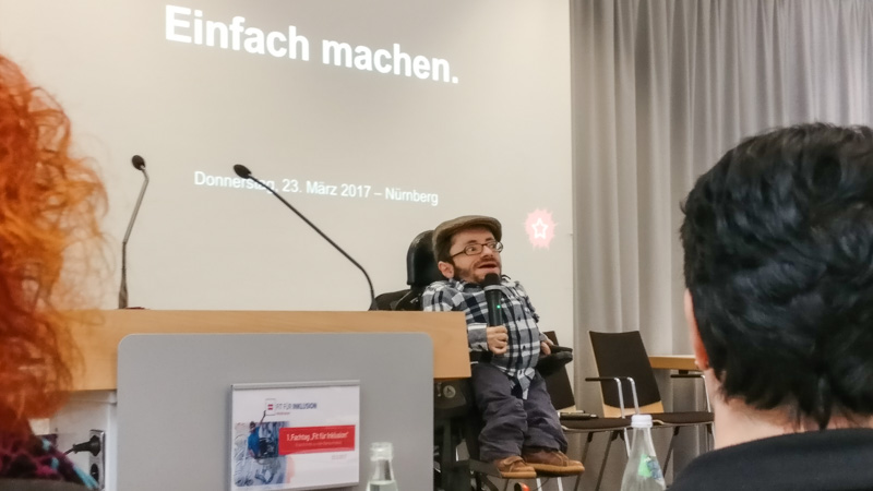 Raúl Krauthausen holding a keynote titled "Einfach machen" ("Simply make it / Make it simple")